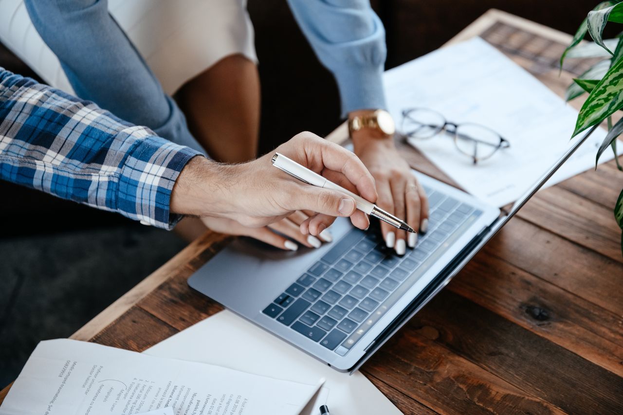Business professional reviewing contracts and digital documents on a computer